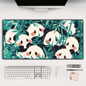 May include: A green and white mouse mat featuring a design of cute cartoon pandas in a bamboo forest. The pandas are white with black eyes and ears, and they are surrounded by green leaves and bamboo stalks.