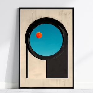 May include: A framed wall art print featuring a beige background with a large black circular archway. Inside the circle is a bright blue sky containing a small, solid orange circular sun or moon positioned in the upper left quadrant of the blue area.