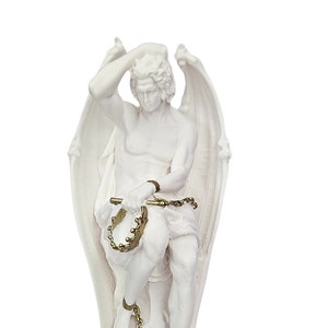 May include: A white statue of a winged figure, possibly an angel or mythological being, with a pensive expression. The figure is adorned with a golden chain and key. The statue is a decorative item, likely for home decor or as a collectible.