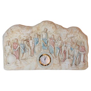 May include: A beige stone-like clock with a round clock face and gold trim. The clock face has black Roman numerals and black hands. The clock is surrounded by a relief sculpture of the twelve Greek gods and goddesses. The sculpture is painted in muted colours and includes the names of the gods and goddesses in Greek.