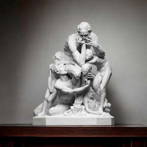 May include: A white marble sculpture depicting a group of figures in a dramatic pose. The figures are intertwined and appear to be struggling or in distress. The sculpture is on a white base.