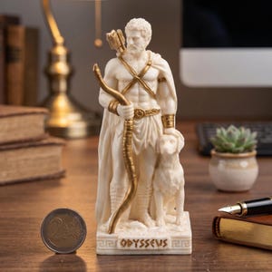 May include: A cream-coloured statue of a muscular man holding a bow and arrow, with a dog at his side. The statue has gold accents and is inscribed with the word "Odysseus". The statue is on a wooden surface.