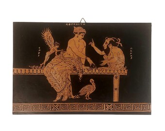 May include: A rectangular, black and orange Greek-style painting. The artwork depicts figures in a classical setting, with the word "APHRODITH" at the top. The figures are seated and interacting, with a bird and a winged figure present. The border features a Greek key design.