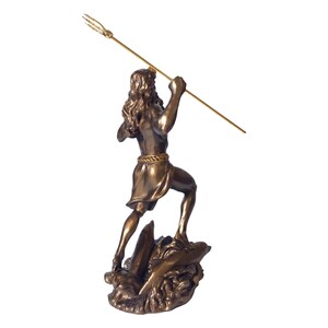 May include: A bronze-coloured statue of a man holding a golden trident, standing on a rocky base. The figure has long hair and is wearing a short tunic. The statue is a decorative item.