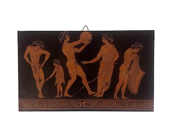 May include: A rectangular, black wooden plaque with a classical Greek scene. The artwork shows several nude figures in terracotta orange, engaged in various activities. A decorative border runs along the bottom edge.
