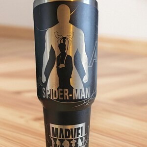 May include: Black stainless steel tumbler with a silver engraved design of Spider-Man, the text "Spider-Man", and the Marvel logo.