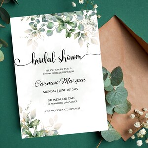 May include: A white bridal shower invitation with a watercolor design of green leaves and gold accents. The text reads "bridal shower" in a cursive font, followed by "Please join us for a bridal shower honoring Carmen Margan" and the date, time, and location of the event. RSVP information is included at the bottom.
