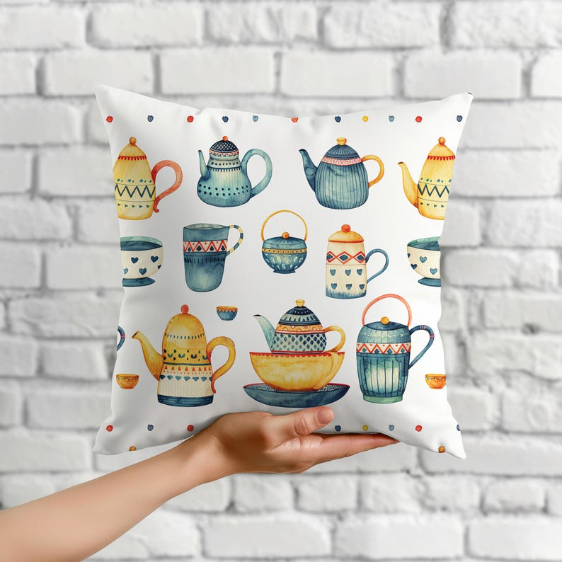 May include: A square throw pillow featuring a white background with a repeating watercolor pattern of various teapots, cups, and bowls in shades of blue, yellow, and red, accented by a border of small colorful dots along the top and bottom.