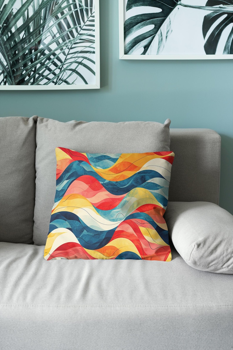 May include: A square throw pillow featuring a vibrant, abstract pattern of flowing, undulating waves in shades of deep blue, bright yellow, and warm red, accented with thin, dark lines that follow the curves of the colorful design.