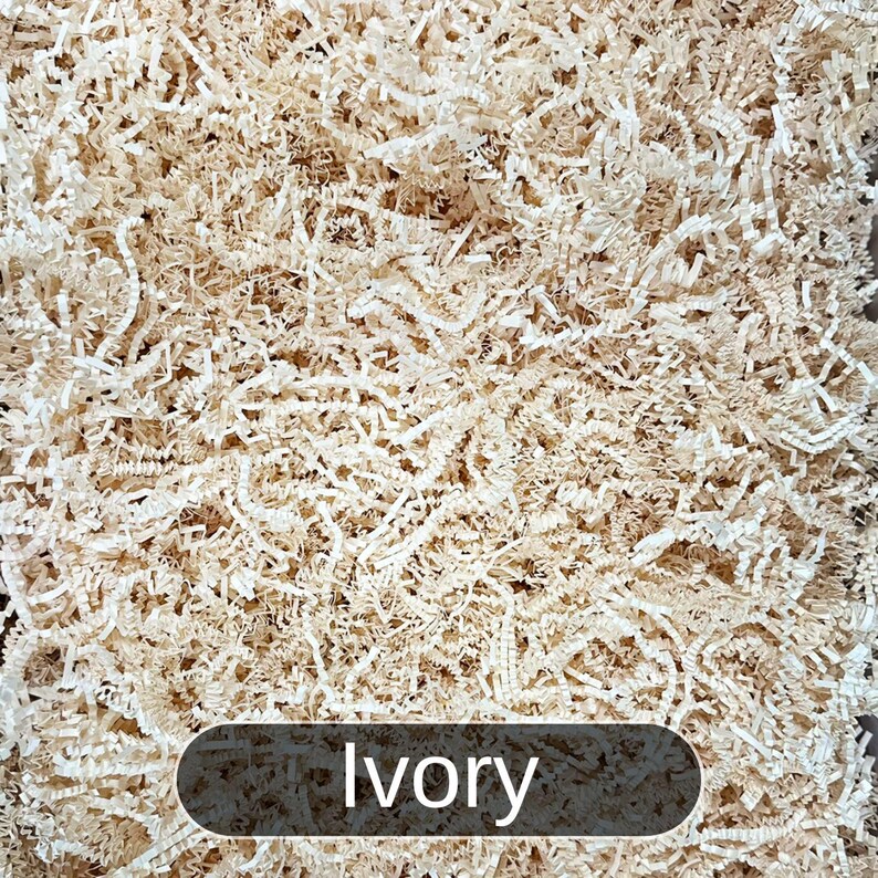 May include: Ivory colored shredded paper, commonly used for packing and gift wrapping.