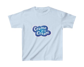 May include: Light blue t-shirt with a blue and white logo that says "Crème de la Cream" in a cloud shape.