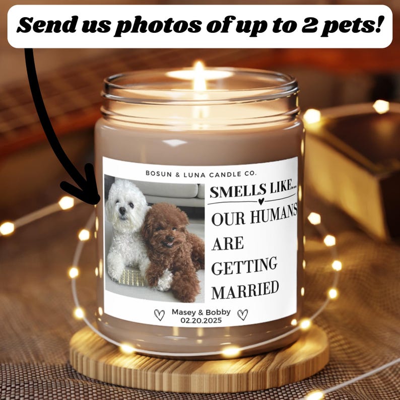 May include: A candle in a glass jar with a label that reads "Smells Like... Our Humans Are Getting Married." The label features photos of two dogs. The text "Send us photos of up to 2 pets!" is at the top.