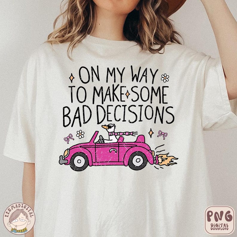 May include: White t-shirt featuring a pink car with a goose at the wheel. The text on the shirt reads "On my way to make some bad decisions."