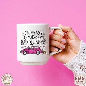 May include: White ceramic mug with a pink car and the text "On my way to make some bad decisions".