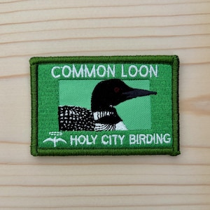 May include: A set of three ceramic mugs with a speckled, matte finish. The mugs are in shades of cream, light gray, and dark gray. Each mug has a simple, minimalist design, perfect for coffee or tea.