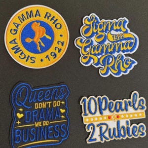 May include: Four embroidered patches with blue and yellow text. One patch reads "Sigma Gamma Rho 1922" in a circular design. Another says "Sigma Gamma Rho 1922" in a cursive font. A third patch reads "Queens don't do drama, we do business". The last patch says "10 Pearls 2 Rubies".