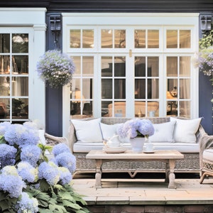 May include: Outdoor patio setting with wicker furniture, including a sofa and chairs, arranged around a wooden coffee table. The scene is adorned with blue hydrangeas, hanging baskets, and climbing greenery, creating a serene ambiance.