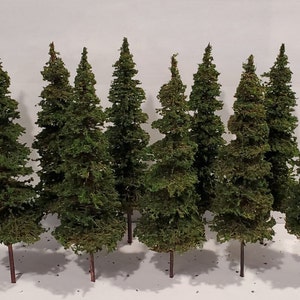 May include: A set of ten miniature green pine trees with brown wire stems. The trees are made of a soft, fuzzy material and are perfect for adding a touch of nature to model train layouts, dioramas, or other craft projects.