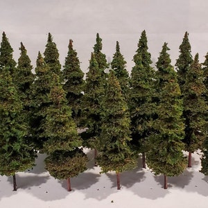 May include: A collection of 15 miniature evergreen trees, ideal for model railways or miniature landscaping. The trees are made of a green, mossy material and have brown trunks.