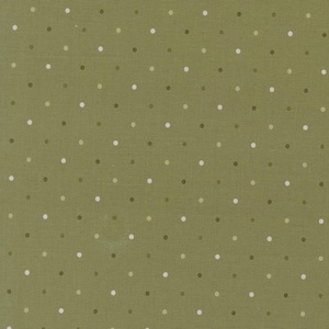 May include: Close-up of a fabric with a repeating polka dot pattern. The background is a muted olive green, and the dots are in shades of white, light green, and dark green. The fabric has a subtle texture.