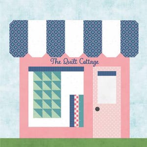 May include: A pink building with a blue and white striped awning and the text "The Quilt Cottage." The building has a door with a black doorknob and a window displaying a quilt pattern. The background is light blue.