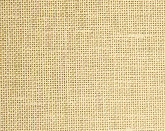 May include: Close-up of a tan burlap fabric with a woven texture. The fabric has a grid-like pattern created by the interwoven threads. The color is a light, neutral tone, suitable for various craft and design projects.
