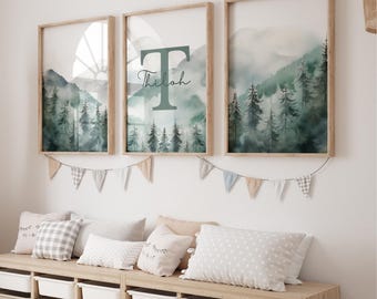 May include: Three framed watercolour prints with a mountain and forest scene. The middle print features the letter T and the name "Thilah" in cursive.