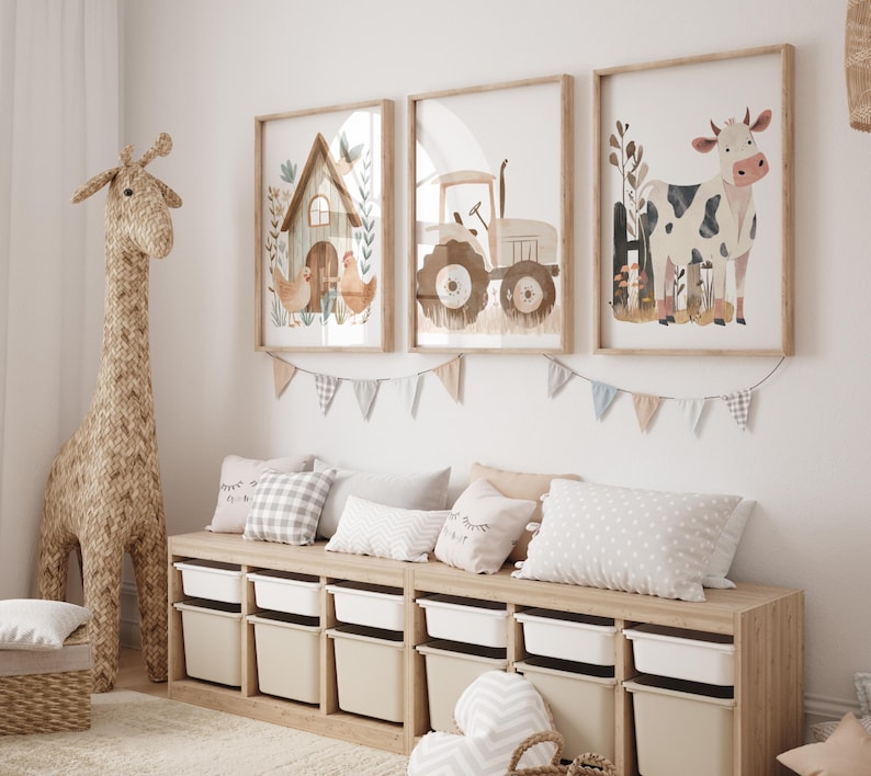 May include: A light wood bench with six storage bins. The bench is decorated with three framed illustrations. The illustrations are of a farmhouse, a tractor, and a cow. The bench is in a nursery with a woven giraffe toy and a white rug.