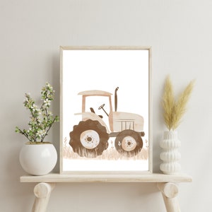May include: Watercolor print of a beige tractor with brown wheels and accents, set against a white background. The tractor is framed in a light wood frame. The artwork is displayed on a light wood shelf with decorative vases and plants.