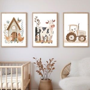 May include: Set of three framed watercolor prints featuring farm animals and a tractor. The first print shows a barn with two chickens. The second print depicts a cow. The third print shows a tractor. All prints have a white background.
