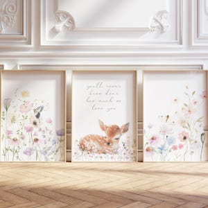 May include: Three framed watercolour prints with a floral theme. The centre print features a sleeping fawn with the text "you'll never know dear how much we love you". The prints are perfect for a nursery or child's room.