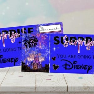 May include: Two blue Disney surprise trip tickets with fireworks and castle imagery. The tickets read "Surprise, You are going to Disney" with the name "Hannah" on one. A Disney-themed gift.
