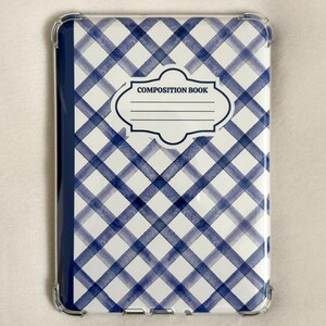 May include: A clear protective case for a tablet or e-reader with a blue and white plaid pattern. The case has a label that reads "COMPOSITION BOOK". The case is designed to protect the device from scratches and damage.