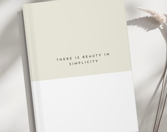 May include: A light green and white journal with the text "THERE IS BEAUTY IN SIMPLICITY" printed on the front cover.