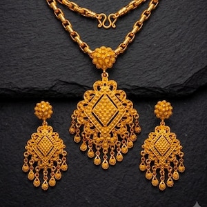 May include: A gold jewelry set consisting of a necklace and two matching earrings. The necklace features a thick chain and a large, diamond-shaped pendant with intricate filigree and dangling gold beads. The earrings mirror the pendant design.