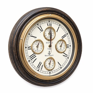 May include: Circular wall clock with a dark brown wooden surround and a cream-coloured face. The clock has Roman numerals, gold accents, and four smaller dials showing world time zones. The text "WORLD TIME NAUTIKRAFT" is printed on the face.