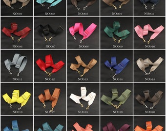 May include: Twenty-five different colored and patterned straps for bags. The straps are made of fabric and have gold metal clasps. The straps are arranged in a grid pattern.