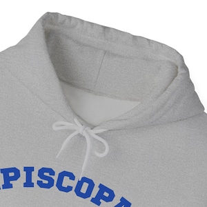 May include: A gray hooded sweatshirt with a blue embroidered word "PISCOPE" on the front.