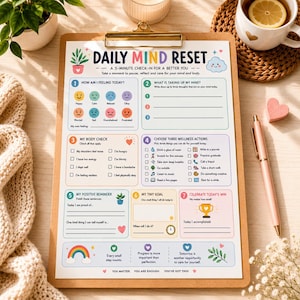 May include: A Daily Mind Reset clipboard featuring a 5-minute check-in sheet with colourful sections for feelings, body checks, wellness actions, goals, and wins. The paper includes icons like a rainbow, trophy, and plant, with text prompts for daily reflection and self-care.