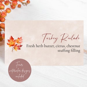 May include: A printable Thanksgiving dinner menu card with a watercolor illustration of autumn leaves. The text reads "Turkey Roulade, Fresh herb butter, citrus, chestnut stuffing filling". The card also includes a small circle with the text "Four watercolor designs included".