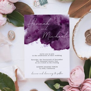 May include: Purple watercolour wedding invitation with the names Hannah and Michael, the date Saturday, the fourteenth of December, Two thousand twenty-four, At six o'clock in the evening, the location Scripps Seaside Forum, La Jolla, California, and the text "Dinner and dancing to follow".