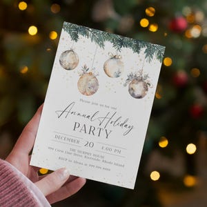 Pu&ograve; includere: Un invito bianco con un design ad acquerello di addobbi natalizi appesi a rami di pino. Il testo sulla carta recita "Unisciti a noi per la nostra festa annuale di Natale, 20 dicembre, 16:00, The Murphy House, 999 Crest Line Drive, Riverside, Rhode Island, RSVP ad Alena al 999 999 9999".