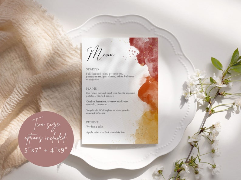 May include: A printable wedding menu card with a watercolor background in shades of red, orange, and yellow. The menu includes starter, mains, and dessert options. The text reads "Menu", "Starter", "Fall chopped salad, persimmons, pomegranate, goat cheese, white balsamic vinaigrette", "Mains", "Red wine braised short ribs, truffle mashed potatoes, roasted brussels", "Chicken forestiere, creamy mushroom marsala, broccolini", "Vegetable Wellington, smoked gouda, mashed potatoes", "Dessert", "Wedding cake", "Apple cider and hot chocolate bar".