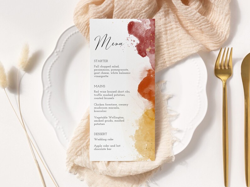May include: A wedding menu with a watercolor background in shades of red, orange, and yellow. The menu lists the starter, mains, and dessert options. The text reads: "Menu", "Starter", "Fall chopped salad, persimmons, pomegranate, goat cheese, white balsamic vinaigrette", "Mains", "Red wine braised short ribs, truffle mashed potatoes, roasted brussel", "Chicken forestiere, creamy mushroom mariala, broccolini", "Vegetable Wellington, smoked gouda, mashed potatoes", "Dessert", "Wedding cake", "Apple cider and hot chocolate bar".