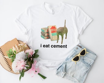 T-shirt avec imprimé Je mange du ciment. Je mange du ciment. Putain de chat. Mème drôle.