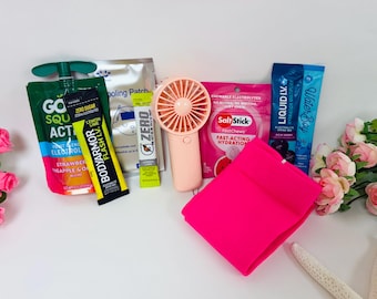 May include: A collection of items including a green GoSqueezy pouch, a yellow BodyArmor Flash I.V. stick, a silver cooling patch, a yellow Zero stick, a peach handheld fan, a pink SaltStick pouch, a blue Liquid I.V. stick, and a bright pink fabric.