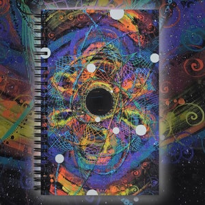 May include: A spiral bound notebook with a colorful, abstract design featuring a black hole surrounded by swirling colors and white dots. The cover is a dark background with a vibrant, psychedelic pattern.