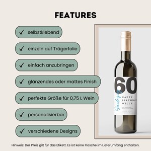 May include: A white wine bottle label with a black and white design. The label features the number 60, the words "Happy Birthday Willy", and the text "Sechzige" in a blue cursive font. The label is designed for a 0.75 liter wine bottle.