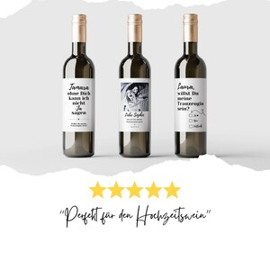 May include: Three wine bottles with personalized labels. The labels feature text in German and a black and white photo of two women. The text on the labels reads "Jamara ohne Dich kann ich nicht Ja sagen", "Liebe Sophie" and "Laura, willst Du meine Trauzeugin sein?"