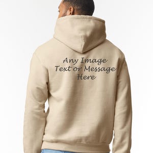 May include: A beige hoodie with a hood and a drawstring. The back of the hoodie has the text "Any Image Text or Message Here" printed in black.